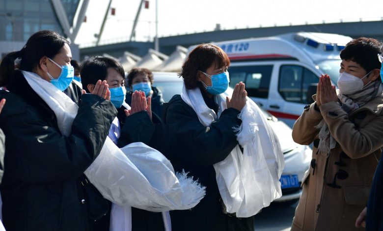 Doctor holding 51 extracted objects from a woman's body, medical team observing in background