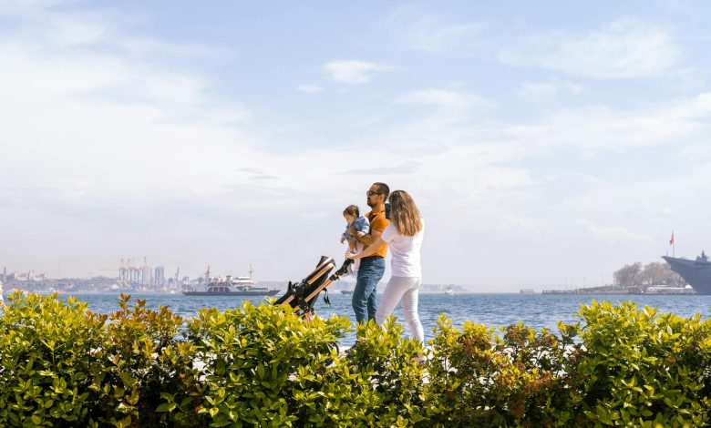 A baby with eczema on cheeks lying on a white blanket looking up with curiosity