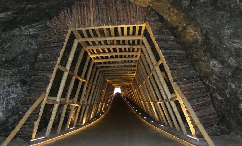 Doctor in surgical attire performing heart surgery in an operating room with medical equipment and team assisting