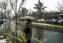 Kocaelispor and Göztepe players in action on the field during a football match, with a stadium crowd in the background