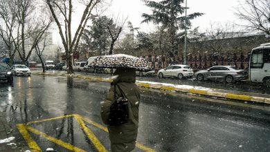 Kocaelispor and Göztepe players in action on the field during a football match, with a stadium crowd in the background